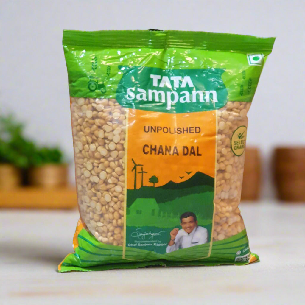 Packaged TATA Sampann Unpolished Chana Dal with green and orange label on a cardboard background